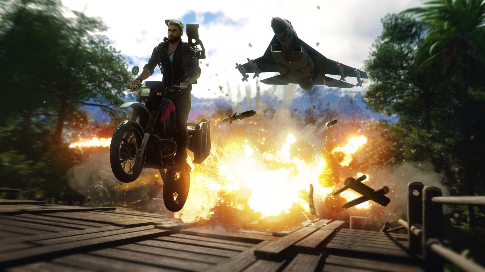 Il protagonista di Just Cause 4 salta con una moto mentre alle spalle vi è un'esplosione e un aereo