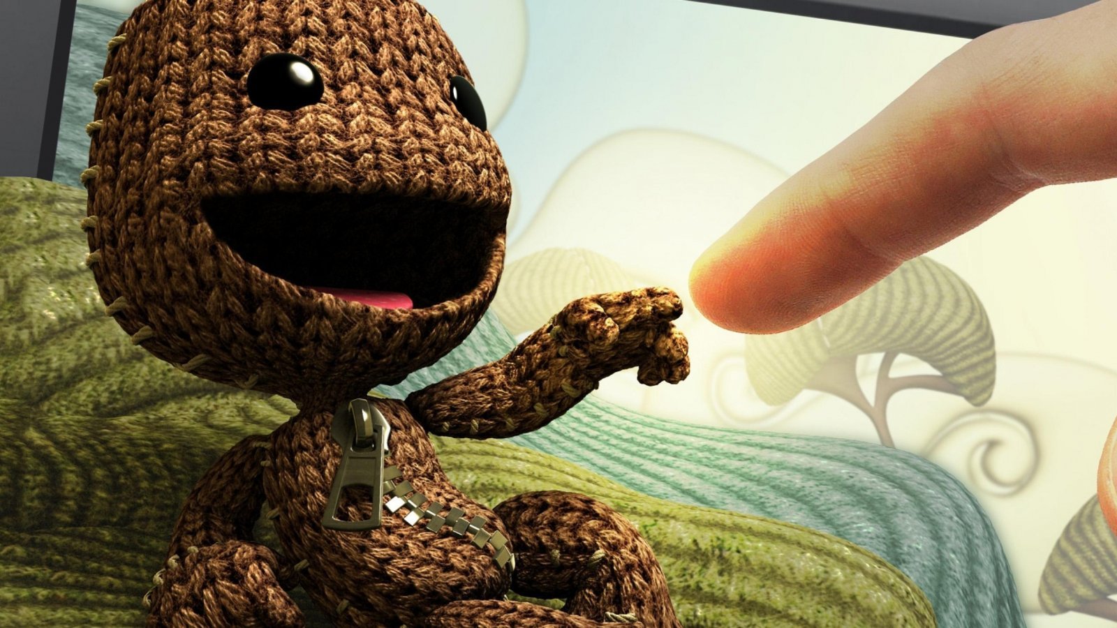 Sackboy con un dito di una persona a fianco