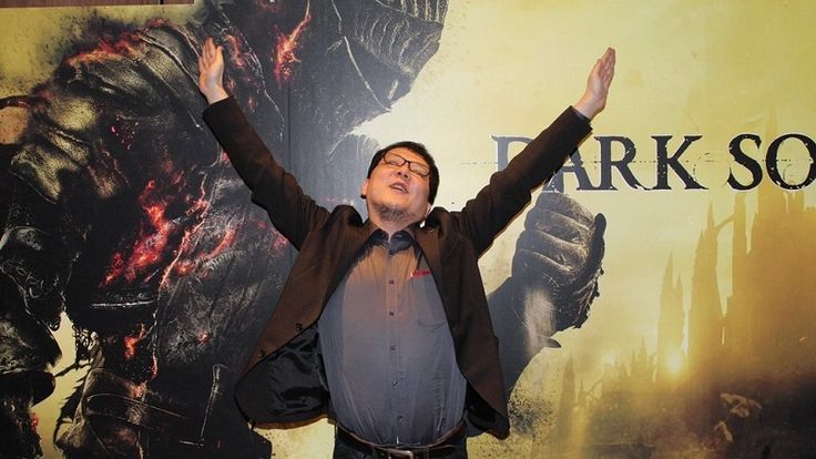 Hidetaka Miyazaki mimes the famous 'Praise the Sun' gesture from Dark Souls